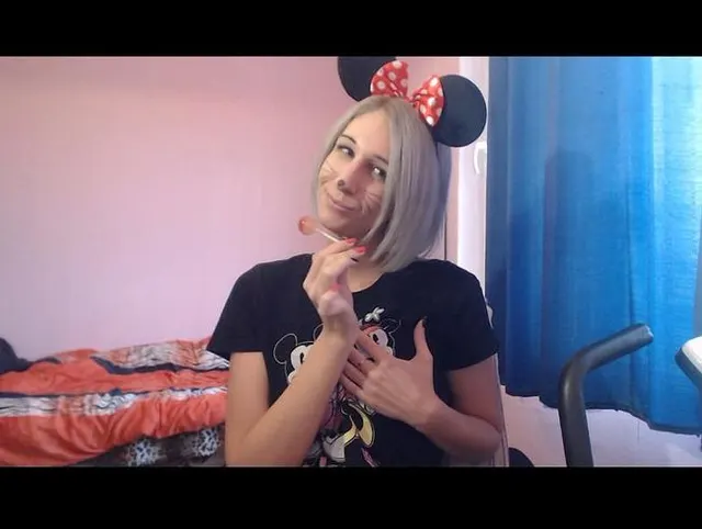Minnie playing with her lollipop