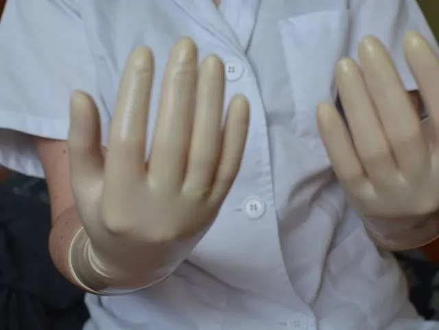 Nurse With Surgical Gloves Milking Patient